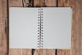Open blank paper book and bullet journal with no writing on the pages, over a dark wooden background Royalty Free Stock Photo