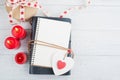 Open blank planner, with lit candles and red heart