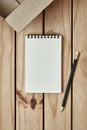 Open Blank Spiral Notebook with Open Empty Cardboard Box and Black Pencil on Wood Table, Online Shopping Flat Lay Concept, Copy Royalty Free Stock Photo