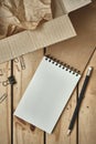 Open Blank Spiral Notebook with Open Empty Cardboard Box and Black Pencil on Wood Table, Online Shopping Flat Lay Concept, Copy Royalty Free Stock Photo