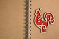 Open blank spiral notepad red wooden rooster Royalty Free Stock Photo