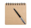 Open blank square notebook of brown kraft paper with a spiral and ballpoint pen lie on a white background Royalty Free Stock Photo