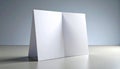 open blank white brochure on table against gray wall Royalty Free Stock Photo