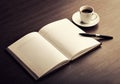 Open a blank white notebook, pen and coffee on the desk Royalty Free Stock Photo