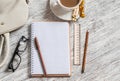 Open a blank white notebook, pen, women's bag, ruler, pencil and cup of coffee