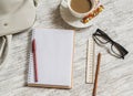 Open a blank white notebook, pen, women's bag, ruler, pencil and cup of coffee Royalty Free Stock Photo
