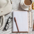 Open a blank white notebook, pen, women's bag, ruler, pencil and cup of coffee Royalty Free Stock Photo