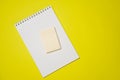 Open blank white notepad on a spiral and stickers on a yellow background. Royalty Free Stock Photo
