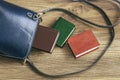 Open blue leather bag on a wooden background with books lying near Royalty Free Stock Photo