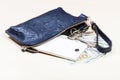 Purse with phone, keys and US dollars on table Royalty Free Stock Photo