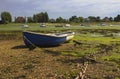 Open boats grounded at low tide in the historic harbour at Bosham in West Sussex in the South of England Royalty Free Stock Photo