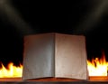 Open book in ambient light with fire Royalty Free Stock Photo