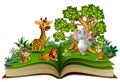 Open book with animal cartoon playing in the park under a big tree Royalty Free Stock Photo