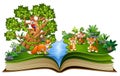 Open book with animal cartoon playing in the park under a big tree Royalty Free Stock Photo