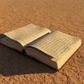 An open book with Arabic script rests on cracked, arid ground. The pages are slightly Royalty Free Stock Photo