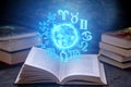 Open book on astrology on a dark background. Glowing magical globe with signs of the zodiac in the blue light Royalty Free Stock Photo