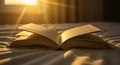 Open book bathed in golden morning light on a cozy bed, symbolizing knowledge and peace Royalty Free Stock Photo