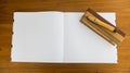 Open Book with Blank Page and Wooden Pencil and Box on Wooden Table Royalty Free Stock Photo
