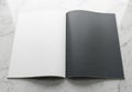 Open book with blank white and dark pages on a textured surface Royalty Free Stock Photo