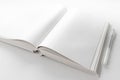 open book with blank white pages on white desk with pen Royalty Free Stock Photo