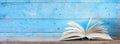 Open book on blue grungy background Royalty Free Stock Photo