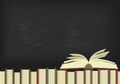 Open book on books with blackboard on background. Royalty Free Stock Photo