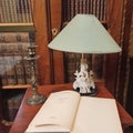 an open book on a brown wooden bedside table