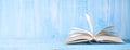 Open book, close up on blue grungy background,reading, education, literature,learning,copy space Royalty Free Stock Photo
