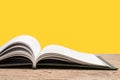 open book. Composition with hardback books, fanned pages on wooden deck table and yellow background. Books stacking. Back to Royalty Free Stock Photo