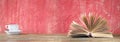 Open Book and cup of coffee, reading, learning, education concept, panoramic format Royalty Free Stock Photo