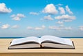 Open book on desk and sea Royalty Free Stock Photo