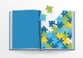 Open book displaying a mix of blank and puzzle-themed pages. The left page is solid blue, while the Royalty Free Stock Photo