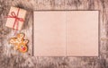 Open book with empty pages, gingerbread and a gift. New Year`s and Christmas. Backgrounds and textures Royalty Free Stock Photo