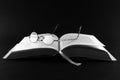 Open book with eyeglasses Royalty Free Stock Photo