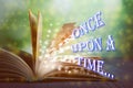 Open book of fairy tales with magic light and text Once upon a time Royalty Free Stock Photo