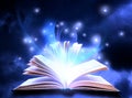 Open book with fairytales and magic lights on background. Creative design Royalty Free Stock Photo