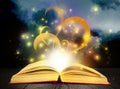 Open book with fairytales and magic lights on table. Creative design Royalty Free Stock Photo