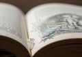 An open book featuring printed text on the left page and an Royalty Free Stock Photo