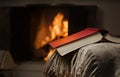 Open book by fireplace.