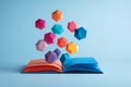 Open book with floating geometric shapes on light blue background, educational concept Royalty Free Stock Photo