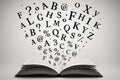 Open book with flying letters and symbols representing language, reading, communication and education on white background Royalty Free Stock Photo