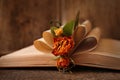 Open book with folded pages and beautiful dried flowers on wooden table, closeup Royalty Free Stock Photo