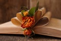 Open book with folded pages and beautiful dried flowers on wooden table, closeup Royalty Free Stock Photo