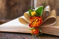 Open book with folded pages and beautiful dried flowers on wooden table, closeup Royalty Free Stock Photo