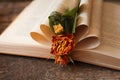 Open book with folded pages and beautiful dried flowers on wooden table, closeup Royalty Free Stock Photo