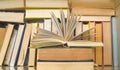 Open book in front of a row of books in a book shelf. Reading, learning, education, literature Royalty Free Stock Photo