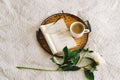 Open book with glasses, cup coffee and bouquet white pink peonies flowers