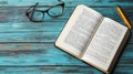 Open book, glasses, pen on teal wood Royalty Free Stock Photo