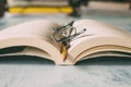 Open book with glasses and pencil on wooden table as background. Education, wisdom and study concept. Royalty Free Stock Photo