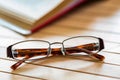 Open book and glasses on wooden table close Royalty Free Stock Photo